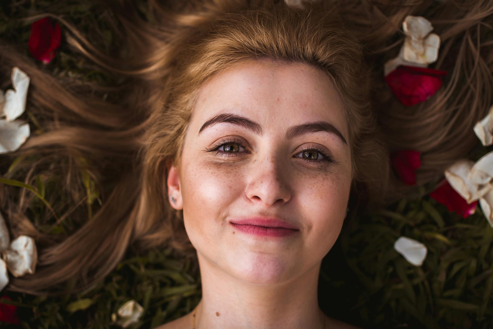 a girl lying down on leaves