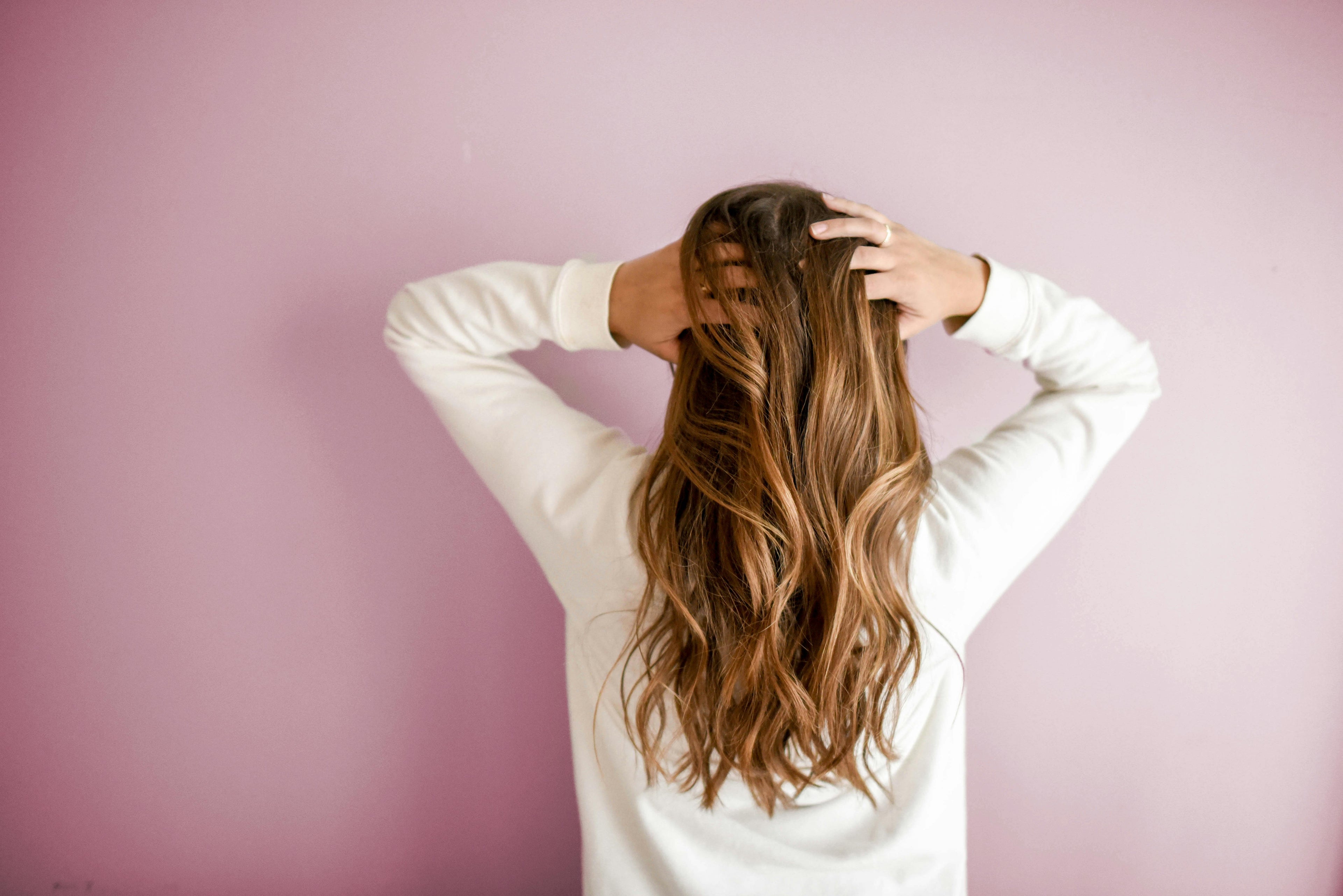 A girl holding her hair.