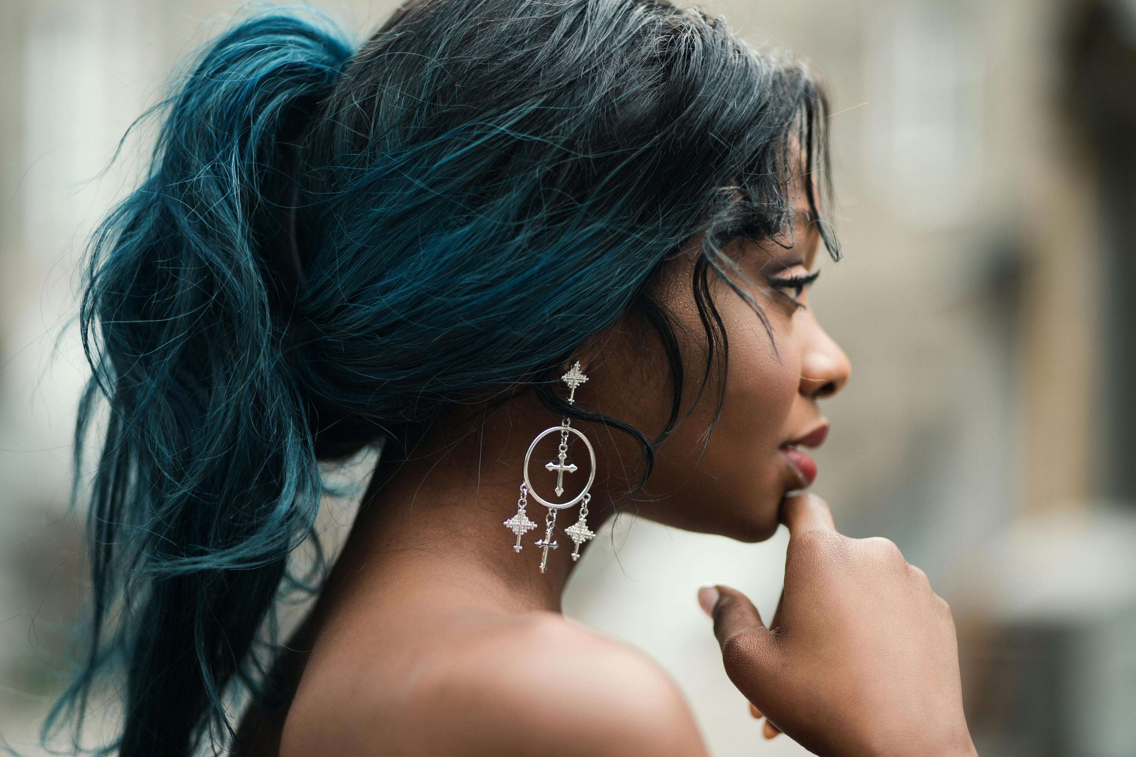 a girl with colored hair holding her chin