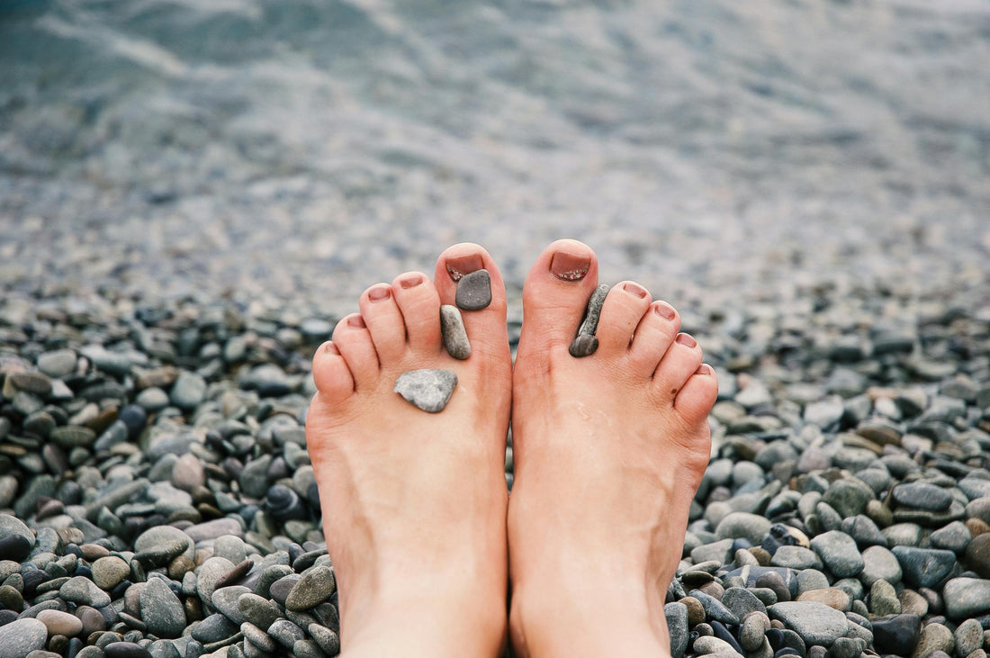 a person sitting in the mountains barefoot