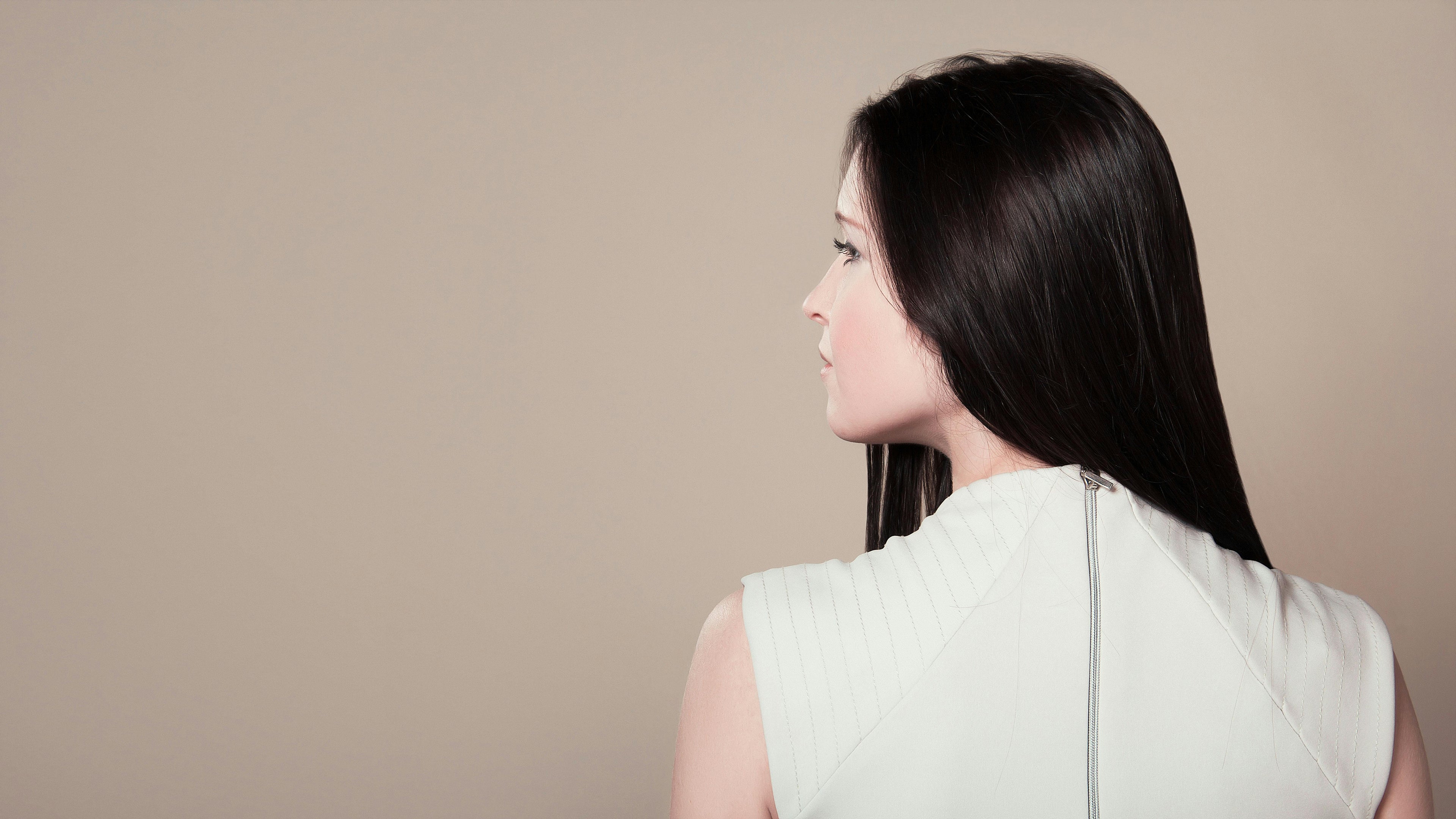 A girl with black hair with her back to the camera