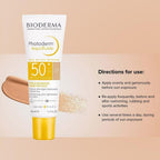 Bioderma Photoderm Aquafluide sunscreen bottle with application instructions on a beige background