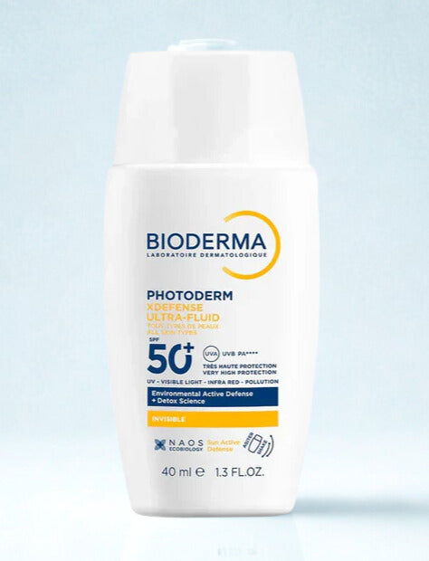 Bioderma Photoderm sun protection cream bottle on a light blue background