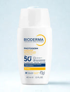Bioderma Photoderm sun protection cream bottle on a light blue background