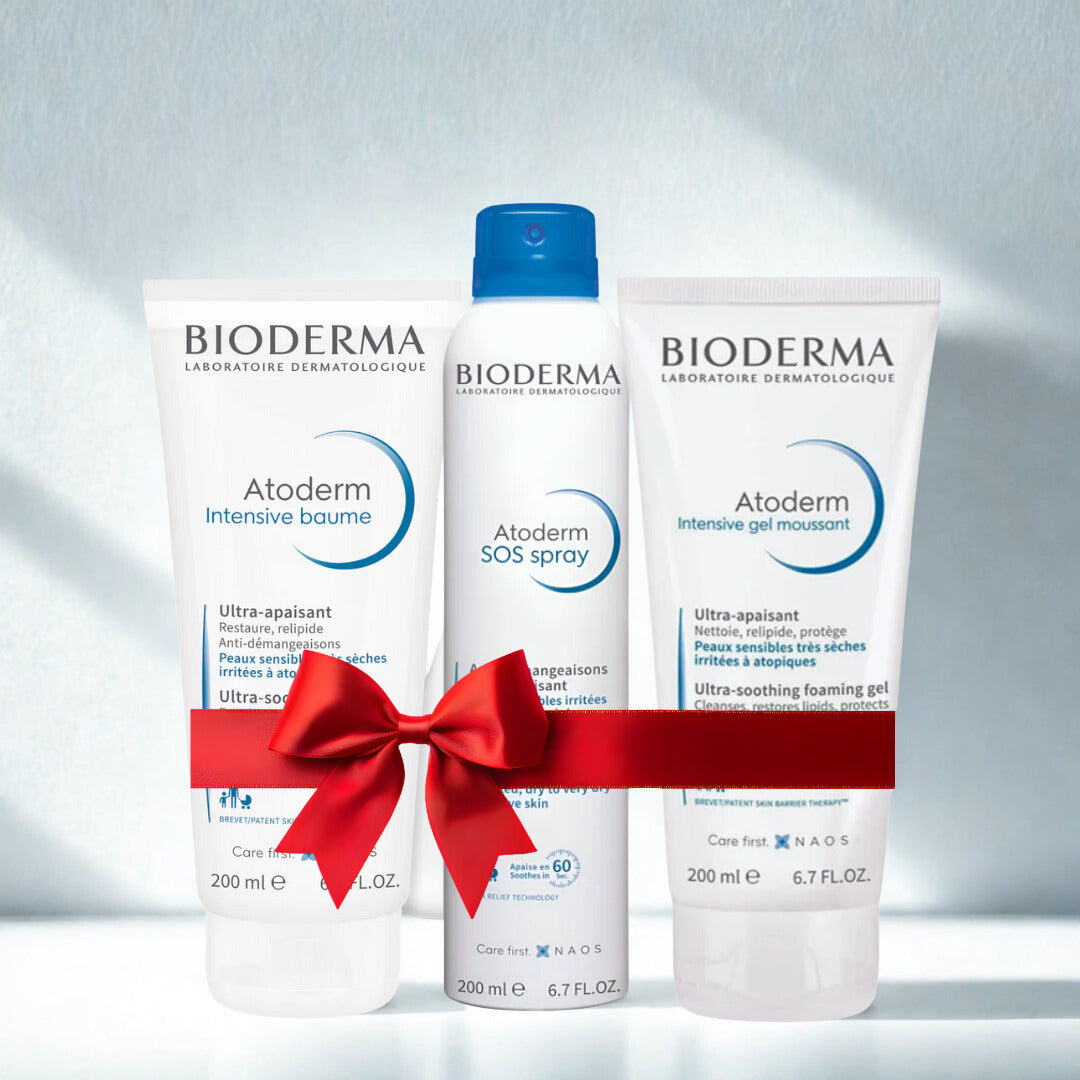 Bioderma Atoderm skincare products with a red bow on a light gray background