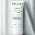Bioderma Sébium Pore Refiner tube on a gray background