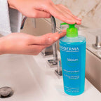 Bioderma Sebium bottle with a hand applying gel from it in a bathroom setting