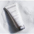 Bioderma foaming cream tube on a textured gray background