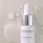 Bioderma skincare bottle with dropper on a textured beige background