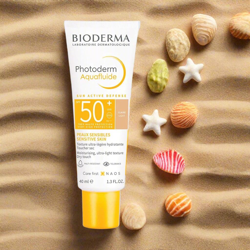 Bioderma sunscreen tube on sand with shells
