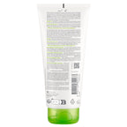 Back view of a green skincare product tube with text and symbols on a white background