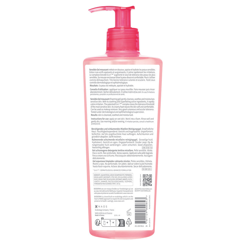 Pink bottle with pump dispenser on a white background
