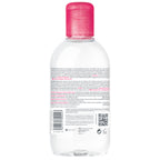 Clear bottle with pink cap on a white background