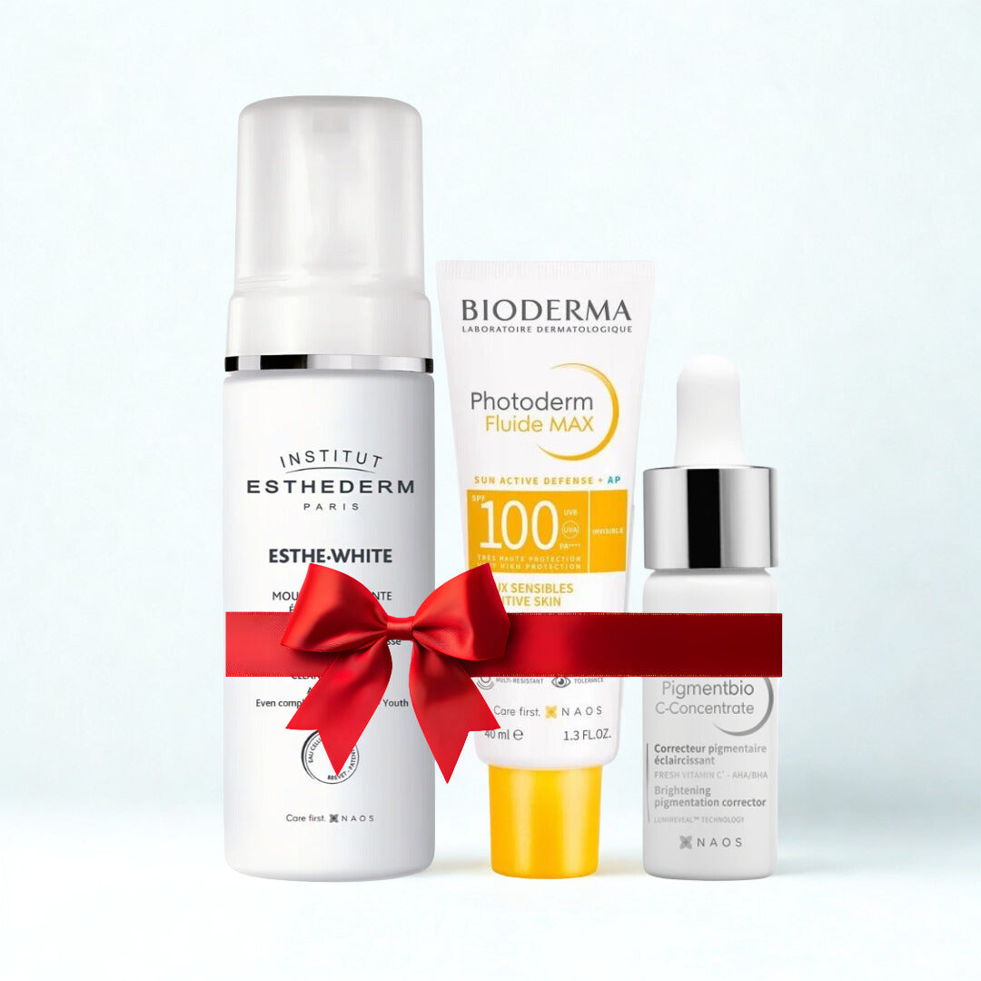 Three skincare products with a red bow on a white background